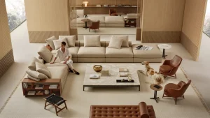 A modern beige living room with a large sectional sofa, a marble coffee table, and a dog near two brown leather chairs while a person sits on the sofa.